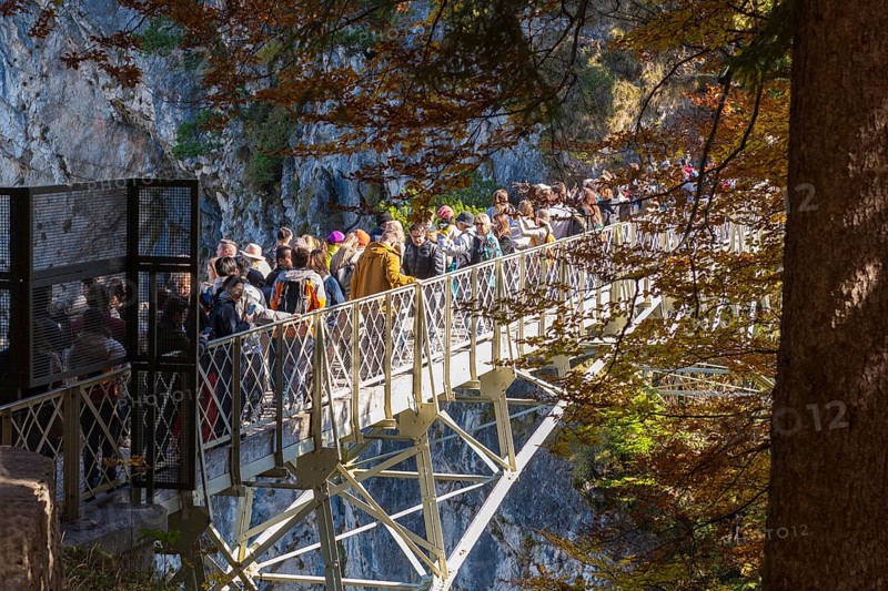 People on the Marienbrücke near Neuschwanstein Castle in autumn, surrounded by trees and rocks, enjoying nature, Schwangau, Königswinkel, Ostallgäu, Allgäu, Swabia, Bavaria, Germany
