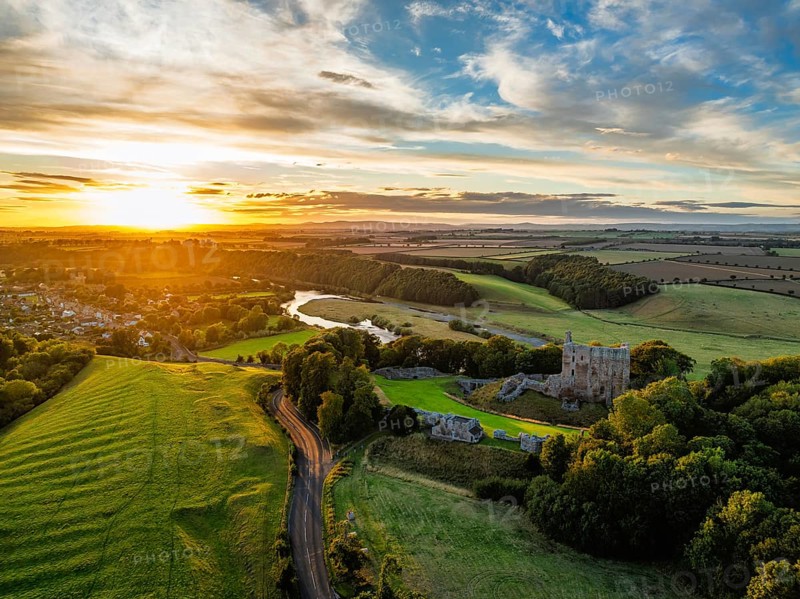 Sunset over Norham Castle and River Tweed from a drone, Norham, Northumberland, England, United Kingdom