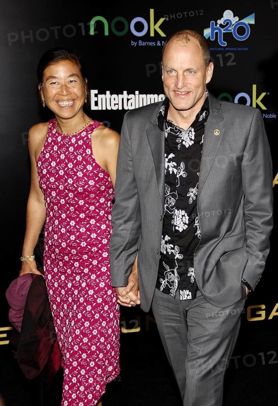 Woody Harrelson and Laura Louie at the Los Angeles premiere of 'The Hunger Games' held at the Nokia Theatre L.A. Live in Los Angeles on March 12, 2012, Los Angeles, CA, USA, Los Angeles, California, USA