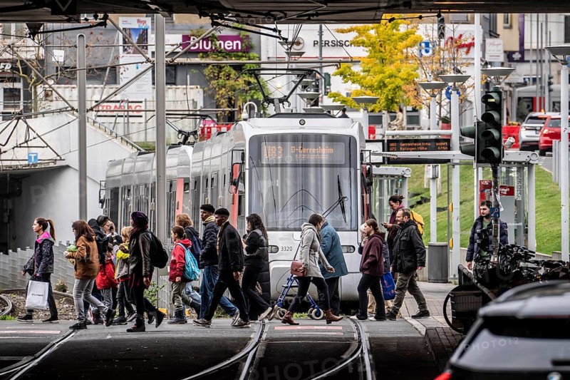 Pedestrians cross the tram tracks, at Düsseldorf-Bilk station, junction of S-Bahn, subway, tram, local bus transport, North Rhine-Westphalia