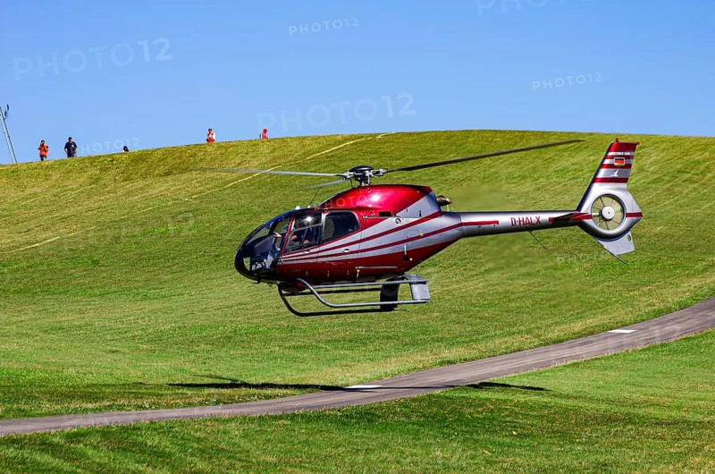 A Eurocopter EC 120B Colibri helicopter, D-HALX registration, during a flight demonstration as part of an air show on Rossfeld in Metzingen-Glems, Baden-Württemberg, Germany, for editorial use only
