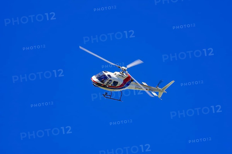 An Aerospatiale AS-350 BA Ecureuil helicopter, registration D-HAAN, from Meravo Air Company during a flight demonstration as part of an air show on Rossfeld in Metzingen-Glems, Baden-Württemberg, Germany, for editorial use only