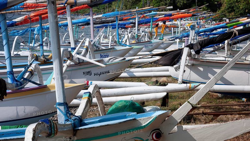 Close-up view of many local small fishing boats outrigger boats on the beach of sea bay near Amed, Amed, Bali, Indonesia