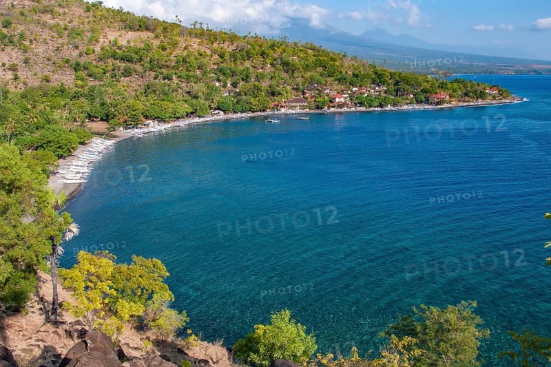 View from an elevated position of many local small fishing boats outrigger boats on the beach of sea bay near Amed, Amed, Bali, Indonesia