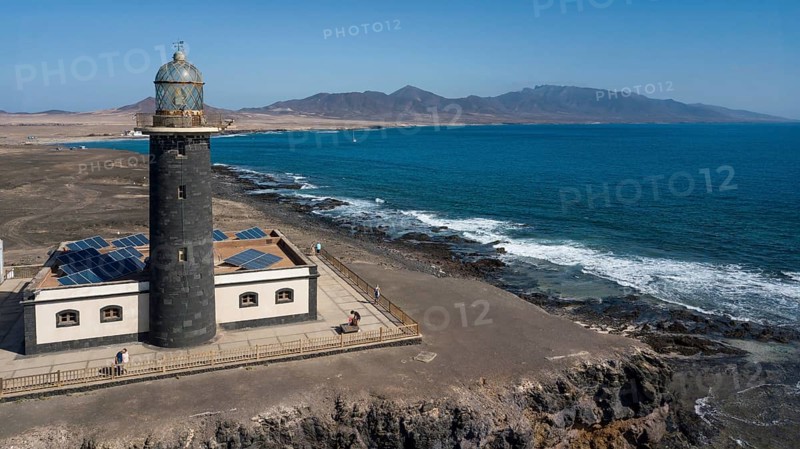 Aerial view of Faro Punta de Jandia lighthouse on a rocky outcrop at the southern tip of Jandia Peninsula, Fuerteventura, Canary Islands, Spain