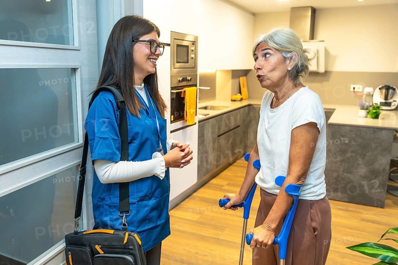 Nurse caregiver entering elderly patients home, providing medical assistance and discussing health, emphasizing home care and rehabilitation support