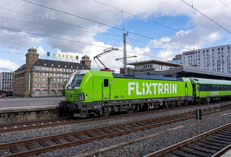 Flixtrain train on track 2 in Essen main station, view of the city center, Handelshof building with Essen lettering, North Rhine-Westphalia, Germany