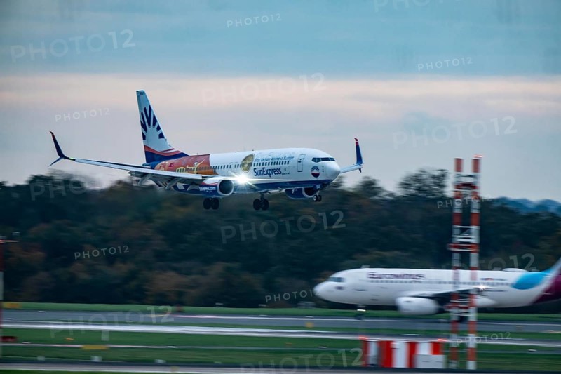 Sunexpress Boeing 737 landing at Düsseldorf airport, Eurowings aircraft waiting for takeoff, North Rhine-Westphalia, Germany