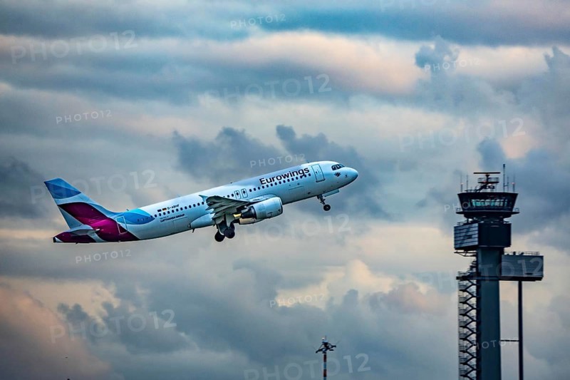 Eurowings Airbus A320 taking off from Düsseldorf Airport, Air Traffic Control Tower, North Rhine-Westphalia, Germany
