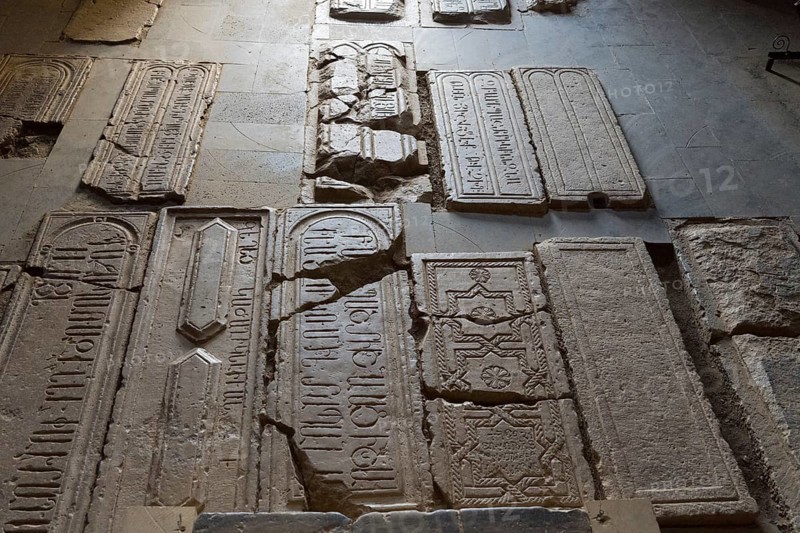 Burial slabs with ancient inscriptions and signs set in the ground, Noravank Monastery, Surb Karapet Baptist Church, Noravank, Vayots Dzor Province, Vayots Dzor, Armenia, Caucasus