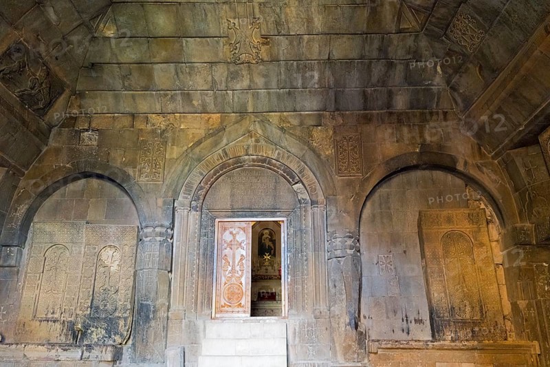 Detail of an ancient stone building with wall engravings and reliefs that conveys a historically religious atmosphere, Noravank Surb Karapet Baptist Church, Vayots Dzor Province, Vayots Dzor, Armenia, Caucasus