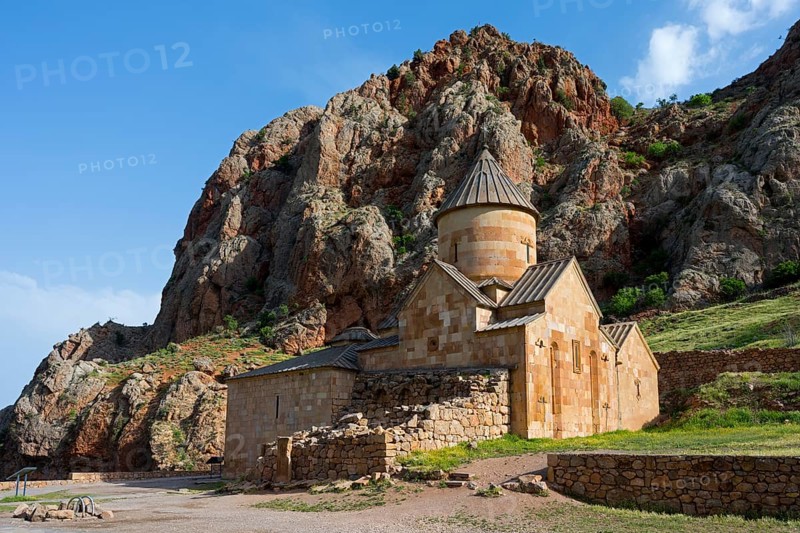 A stone church nestled in a rocky landscape with blue sky in the background, Noravank monastery, Surb Karapet baptism church, Noravank, Vayots Dzor province, Vayots Dzor, Armenia, Caucasus