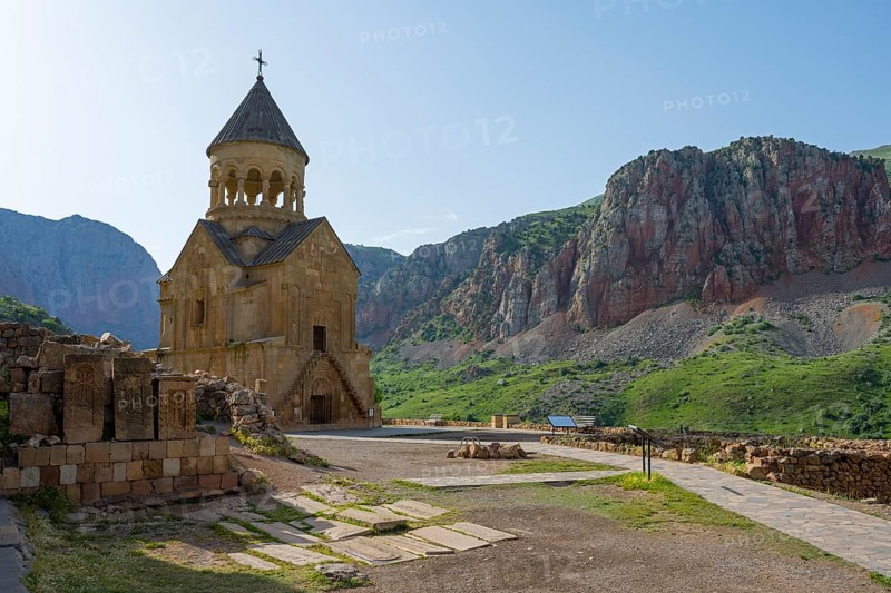 A chapel near a dramatic rock formation and surrounded by lush green landscape, Noravank monastery, Surb Astvatsatsin mausoleum church, Noravank, Vayots Dzor province, Vayots Dzor, Armenia, Caucasus