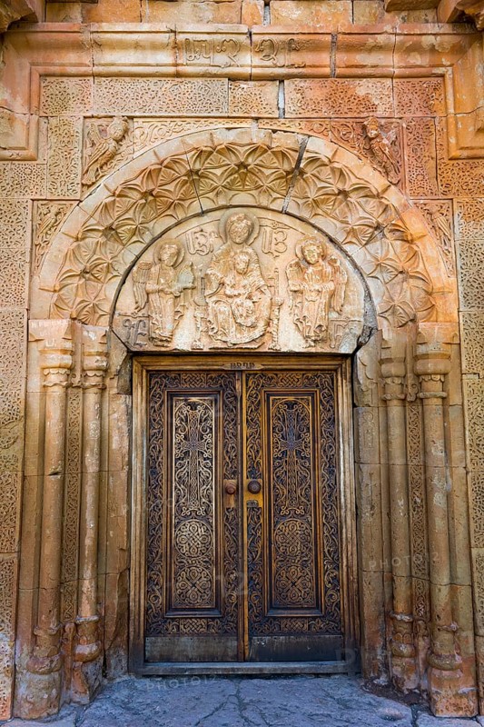 Elaborately carved wooden gate with beautiful stone decorations and architectural details, Noravank monastery, Surb Astvatsatsin mausoleum church, Noravank, Vayots Dzor province, Vayots Dzor, Armenia, Caucasus