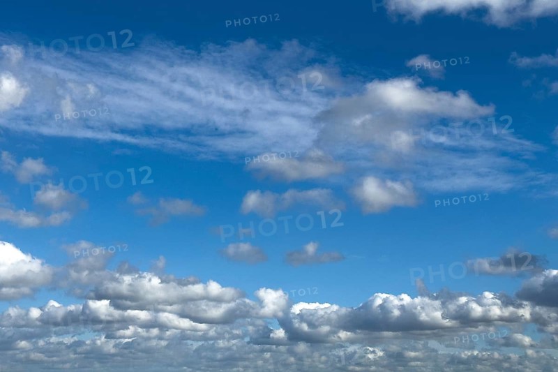 Almost overcast sky with clouds cloud field Cumulus right above Stratocumulus above in the background Cirrus Cirrus clouds above slightly cloudy against blue sky, international