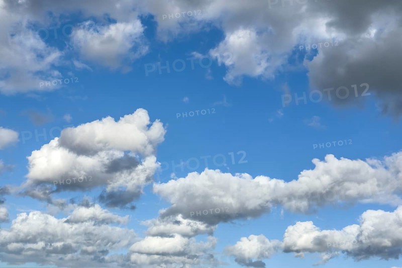 White clouds driven by approaching storm Cumulus Stratocumulus loose to thick cloud against blue sky, international