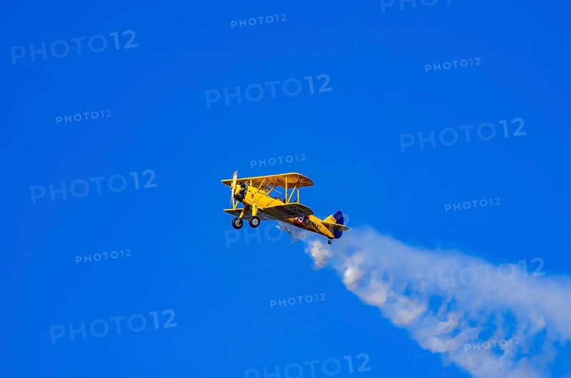A Boeing PT-17 Stearman biplane, also Boeing Stearman Model 75, with the inscription 399 USNAVY N67193 during a flight demonstration as part of an air show on Rossfeld in Metzingen-Glems, Baden-Württemberg, Germany, for editorial use only