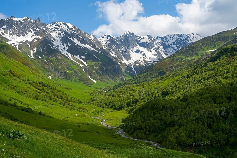 River flows through green valley with snow-covered mountain views, Zagari Pass, Svaneti, Svaneti, Greater Caucasus, High Caucasus, Georgia
