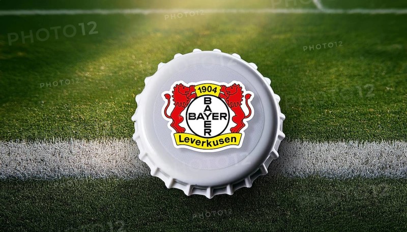 Bottle cap featuring the Bayer Leverkusen logo placed on a football field, representing team pride and passion for the sport in a creative and unique way, AI generated