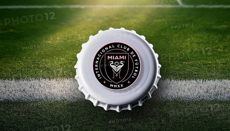 Bottle cap featuring the Inter Miami logo placed on a football field, symbolizing team loyalty and passion for the sport in a creative and stylish presentation, AI generated