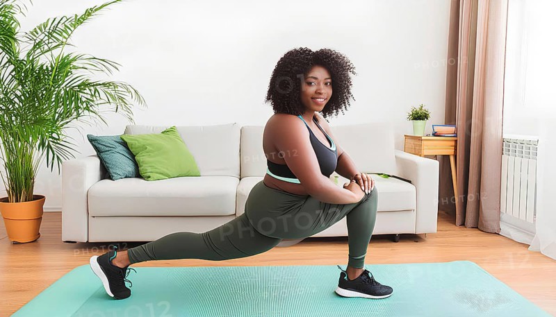 A woman is doing a yoga pose on a mat in a living room. She is wearing a green top and green pants, AI generated