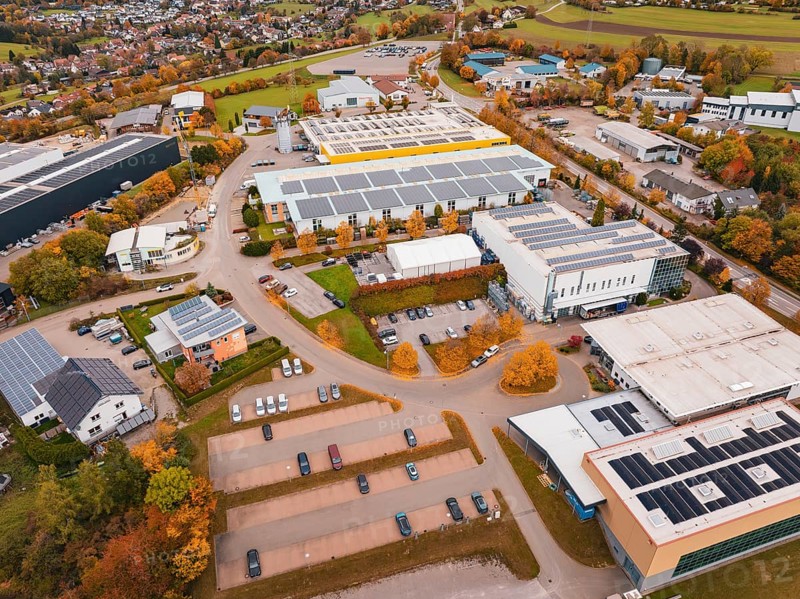 Industrial area with large buildings and parking spaces in an autumn environment, Dornstetten, Freudenstadt district, Germany