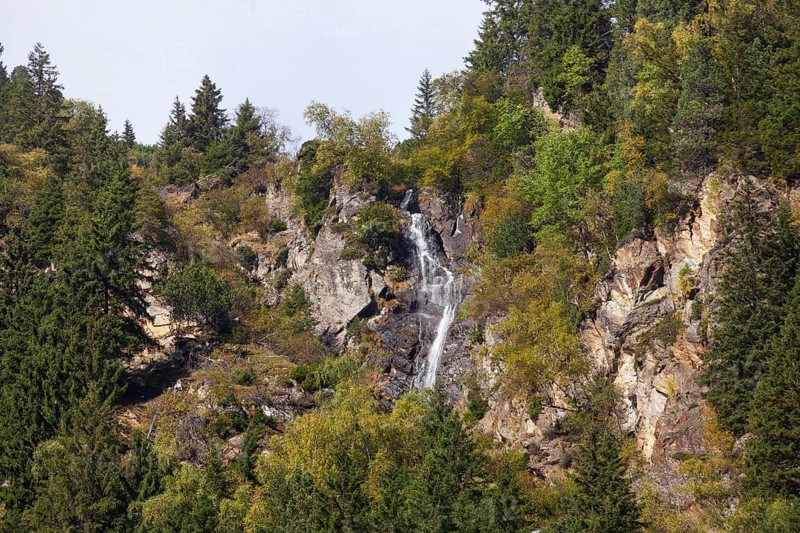 Waterfall with forest and mountains on Wilde Wasser Weg in autumn, WildeWasserweg, Stubai Valley, Tyrol, Austria