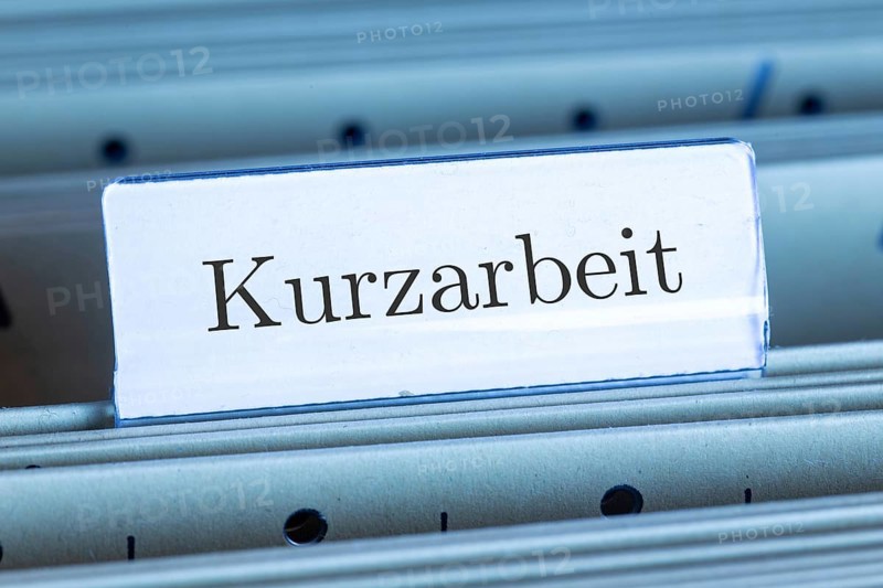 (photo montage) Sign with the inscription KURZARBEIT on a hanging file register
