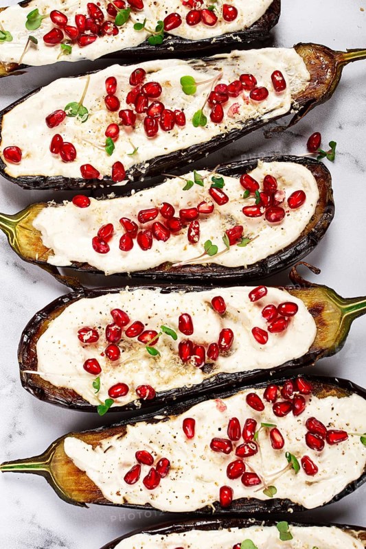 Fried eggplant with sauce, decorated with microgreens and pomegranate seeds, eggplant appetizer, top view, homemade, no people