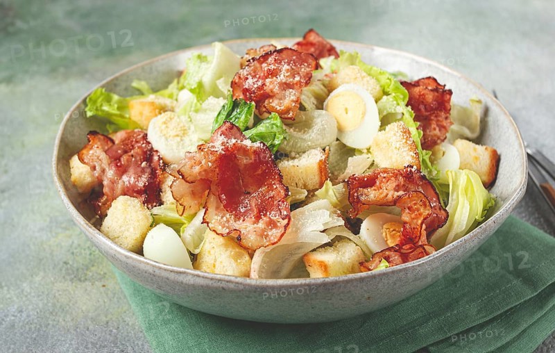 Caesar salad with fried bacon, quail eggs, homemade, no people