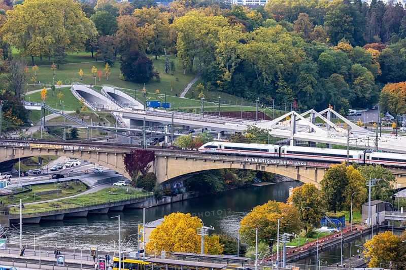 Bridges across the Neckar in Bad Cannstatt with Rosenstein Park. The ICE is still running on the old Rosenstreinbrücke. When the new main train station is completed, the trains will travel across the new Neckar bridge behind it. Stuttgart, Baden-Württemberg, Germany