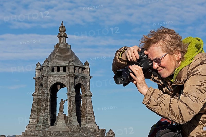 Woman photographing model, Kaiser Wilhelm Memorial, Porta Westfalica, North Rhine-Westphalia, Germany