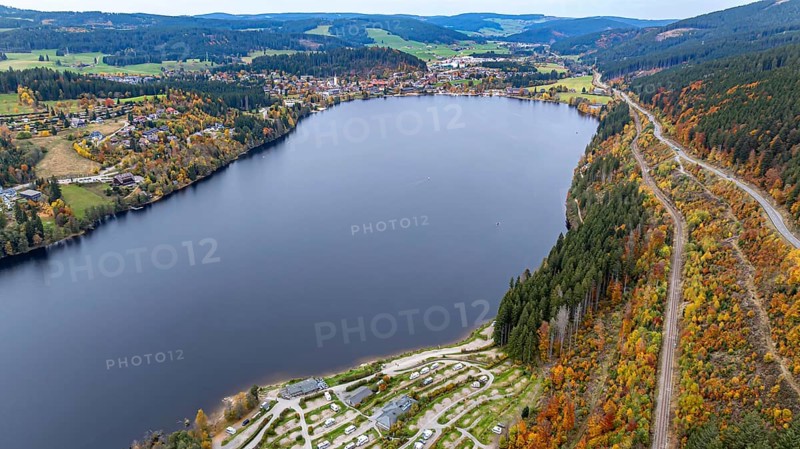 Titisee in the Black Forest around autumn. The landscape around the lake is in bright autumn colors. Drone photo. Titisee-Neustadt, Baden-Württemberg, Germany