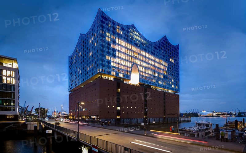 Elbe Philharmonic Hall at the Blue Hour with light strips of vehicles in the foreground and light cloudiness in the background, Hamburg, Germany