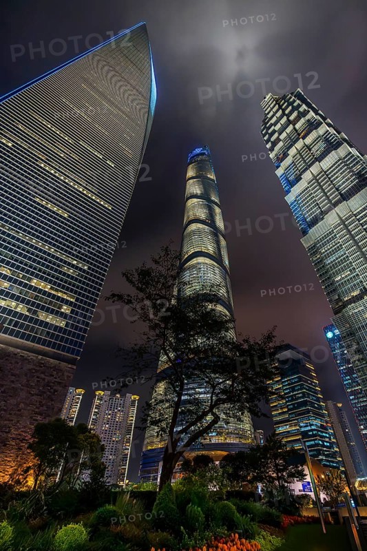 Lujiazui financial district with illuminated skyscrapers, Shanghai Tower, SWFC and Jin Mao Tower in Pudong at the city Shanghai at night, China