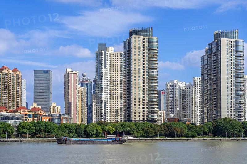 View over the Huangpu River and skyline showing skyscrapers and high-rise flats in the Pudong district of the city Shanghai, China