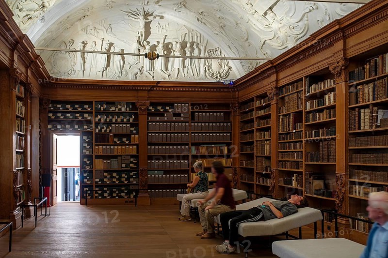 Visitors looking at 17th century stucco on library ceiling of the Park Abbey, Premonstratensian abbey at Heverlee, Leuven, Flemish Brabant, Belgium