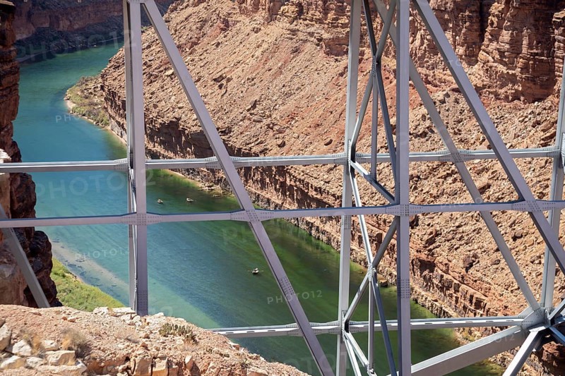Marble Canyon, Arizona - Dories float under the Navajo Bridge which spans the Colorado River in Marble Canyon, headed towards the Grand Canyon