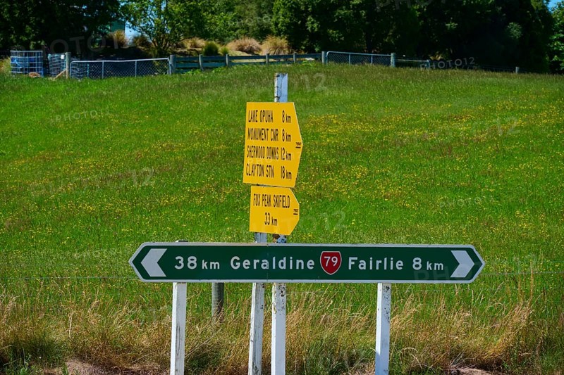 Road signs with distances on green background in rural area, Geraldine, Canterbury, South Island, New Zealand