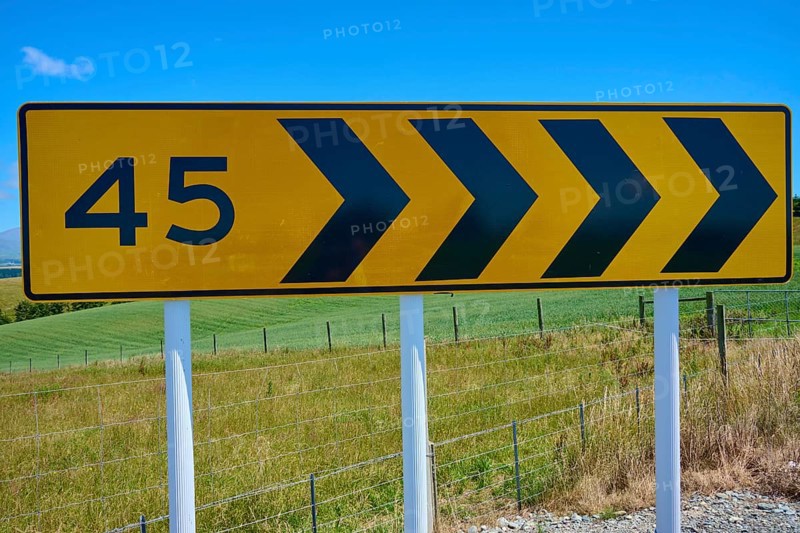 Road sign with arrows and number 45 in front of green landscape, Geraldine Fairlie Lookout, Geraldine, Canterbury, South Island, New Zealand