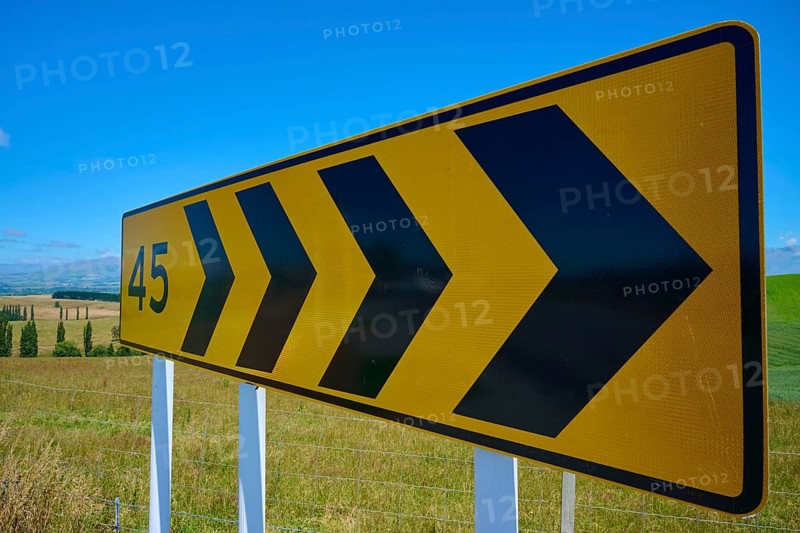 Yellow road sign with black arrows and number 45 on rural road, Geraldine Fairlie Lookout, Geraldine, Canterbury, South Island, New Zealand