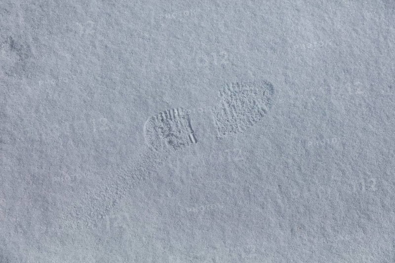 Closeup of boot footprint in snow in spring, Suomusjärvi kirkonkylä, Finland
