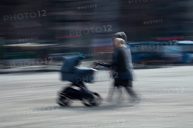 Abstract image of a couple pushing a pram in city captured using ICM intentional camera movement technique, Helsinki, Finland