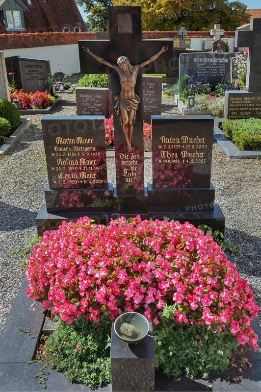 Graves with crucifix and floral decoration in Maria-Thann, Allgäu, Swabia, Bavaria, Germany