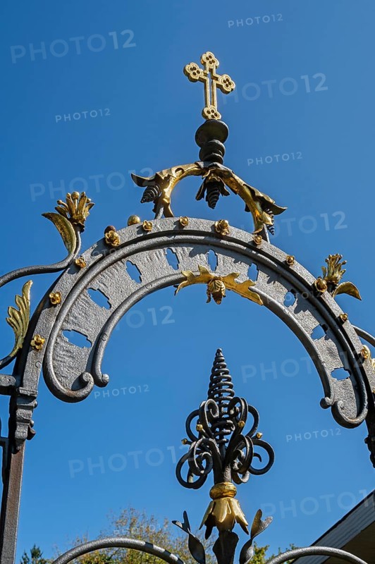 Blue sky and wrought iron gate to the cemetery in Maria-Thann, Allgäu, Swabia, Bavaria, Germany