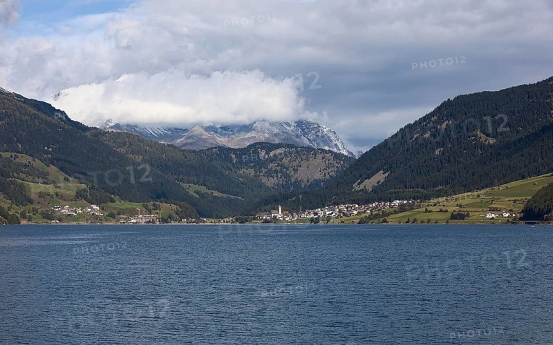 The town of Reschen on Lake Reschen in Italy is surrounded by impressive mountains