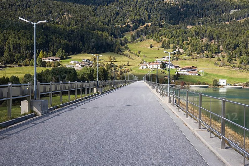 There is a narrow road on the dam that dams Lake Reschen in South Tyrol in Italy