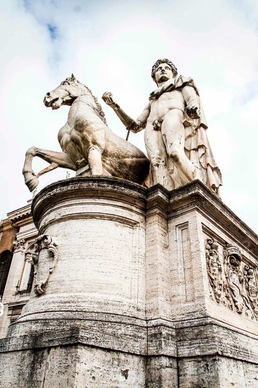 Statue of one of the Dioscuri (Castor and Pollux) on the top of La Cordonata, a sloping road composed of transversal stripes leading to Capitoline Square (Piazza del Campidoglio). Rome, Province of Rome, Italy