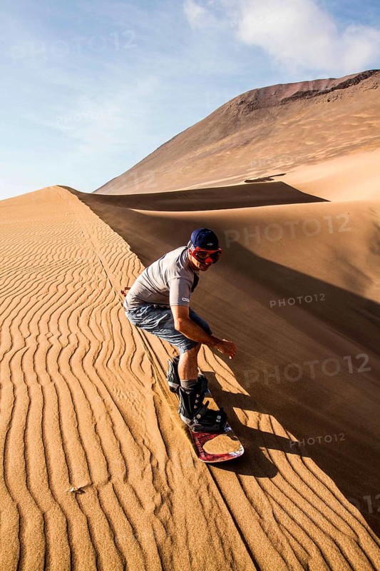 Sandboarding on Caramucho dunes, in Atacama Desert. Iquique, Tarapaca Region, Chile. 21.11.15