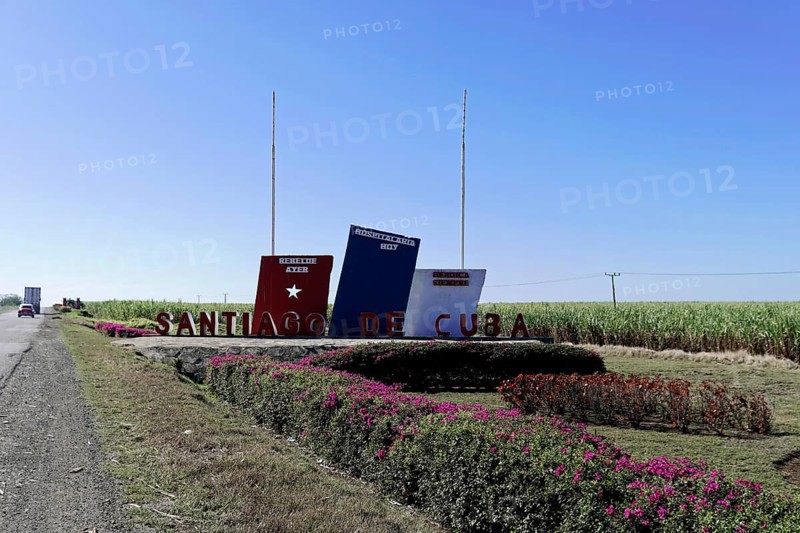 Sign with the word 'Santiago de Cuba' on a field with blue sky, Cuba, Greater Antilles, Caribbean, Central America, America, Central America